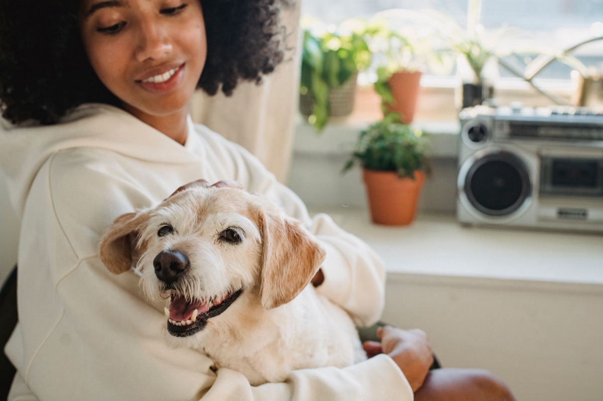 Dog with owner showing affection in suburban yard